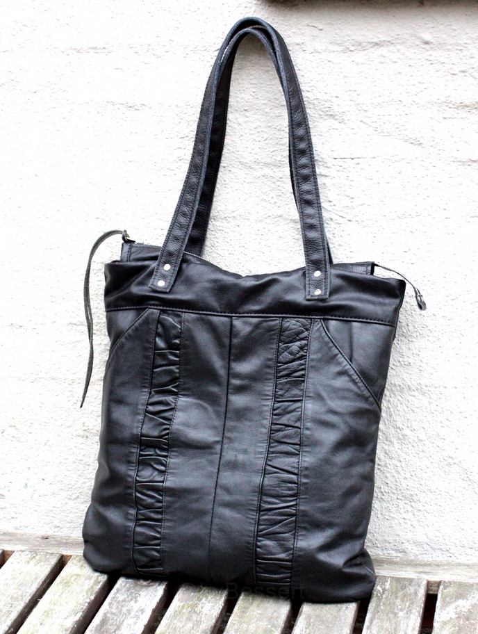 Black city bag made out of a pair of leather trousers. – byBessert